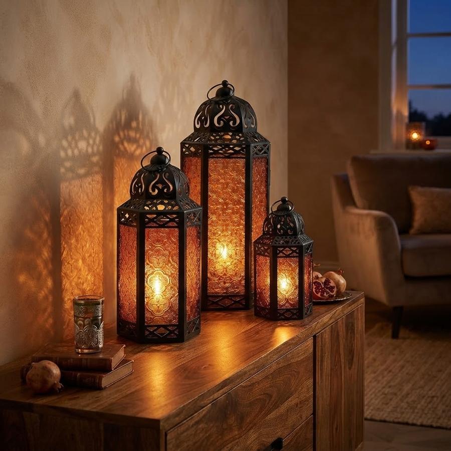 Three amber Moroccan lanterns stepped by height on a runner